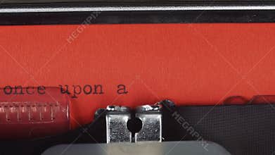 Once upon a time - Typed on a old vintage typewriter. Printed on red paper. The red paper is inserted into the