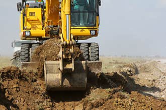 Crawler excavator working on a highway construction site