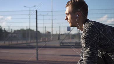 Young man rides a bicycle along the street