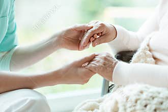 Nurse holding patient`s hands