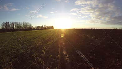 Sunrise over plowed autumn farmland field, time lapse 4K