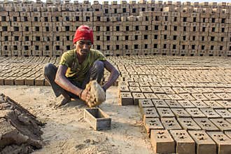 Man removing bricks from mold