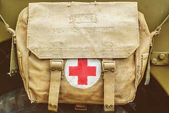 Red cross medical aid symbol on an old army bag