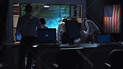 People working in mission control center