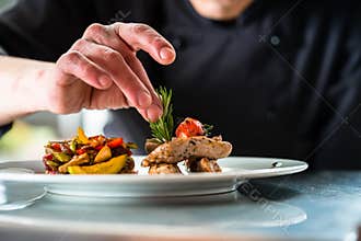Chef finishing and garnishing food he prepared