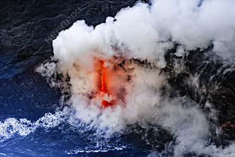 Clouds of steam and rocks fly through the air as Kīlauea erupts and lava clashes with the cold water