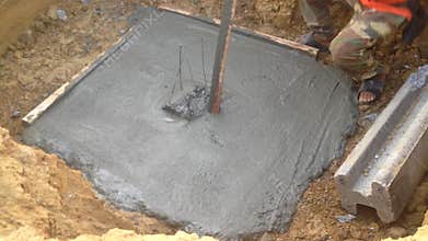 Construction worker plastering around center pile foundation,before use shutter boards and pouring concrete for center pillar