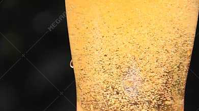 The beer is poured into a glass