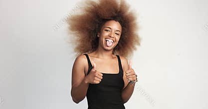 Beuayt black woman with a huge afro hair having fun smiling and showing thumbs up