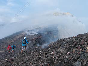 To the top of the Etna volcano, Hikers Exploring the Volcanic Terrain of Mount Etna