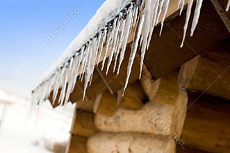 Icicles on an old log-house