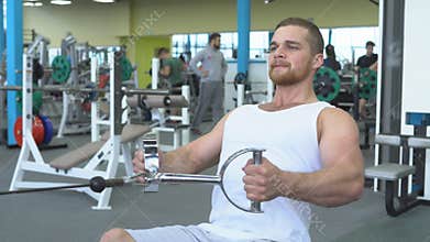 Athletic young man exercising on a block device. Portrait of strong athletic man at the gym training