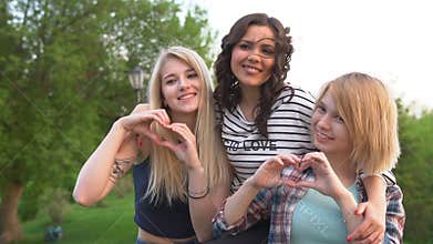 Beautiful girls show their love and make hearts with their hands. best friends together