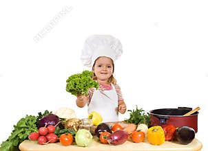 Happy little chef with lots of vegetables
