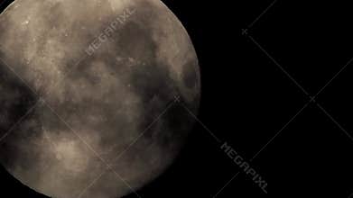 Moon fading in and out of cloud cover