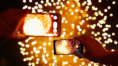 Man records video Fireworks on smart phone