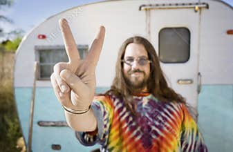 Man in Front of a Trailer Making a Peace Sign