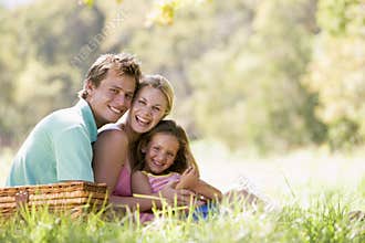 Family at park having a picnic and laughing