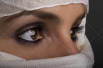 Woman with shawl on face