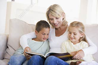 Woman and two children sitting in living room