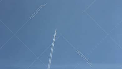 Jet stream of airplane going in blue sky