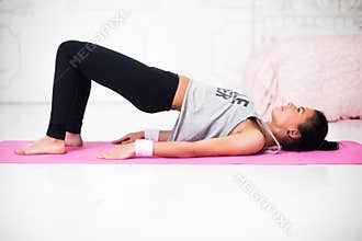 Bridge pose sporty woman doing warming up exercise