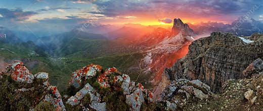 Panorama dramatic sunset in dolomites alp mountain from peak Nuvolau