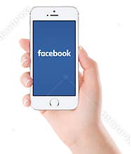 Facebook logo on white Apple iPhone 5s display in female hand