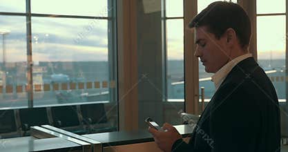 Young man typing sms in airport