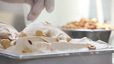 Hazelnut ice cream, professional hands garnish