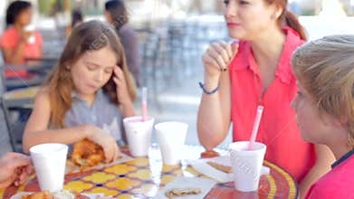 Family Enjoying Snack At Outdoor Cafï¿½