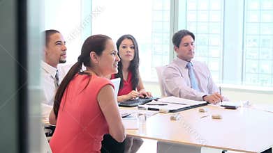Four Businesspeople Having Video Conference In Boardroom