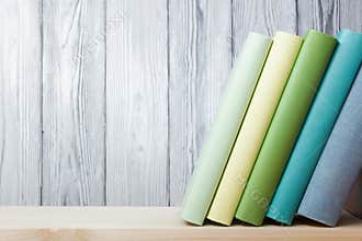 Stack of colorful books on wooden table. Back to school. Copy space