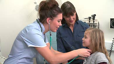 Nurse Listening To Child's Chest In Surgery