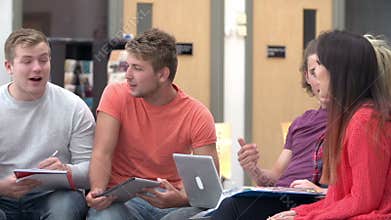 Group Of College Students Sitting And Working Together