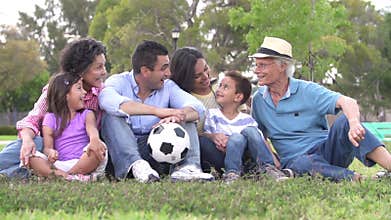 Slow Motion Shot Of Multi Generation Family With Soccer Ball