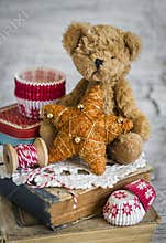 Decorative Christmas star, old books, paper molds for baking, toy bear
