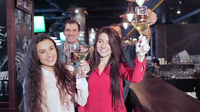 Girls with martini and guys with glasses of beer