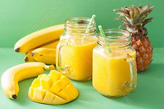 Healthy yellow smoothie with mango pineapple banana in mason jar