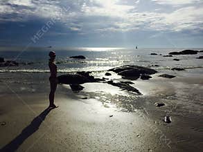 Woman on the beach in sunshine