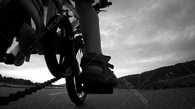 4k Footage of a boy riding a Bicycle at the sunset time; a view from the camera attached to the bicycle's frame