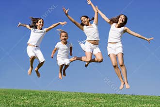 Happy group jumping at summer camp