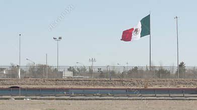 Mexican Flag Waving Near the US and Mexico Border and Highway