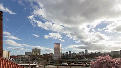Tmelapse of auto and foot traffic with clouds and blue sky over busy streets in Portland OR 4k