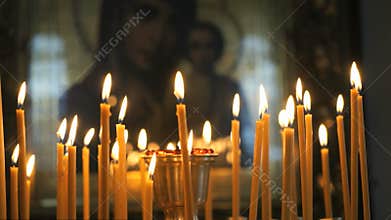 Church candles burn before the icon mother of God