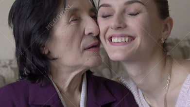 Old woman looking on a window. Girl coming, embracing and smiling. Slowly