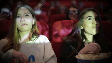 Teenage girls watching movie in cinema