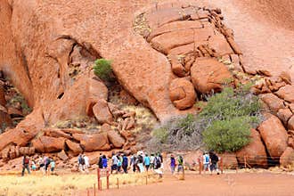 Tourists walk the Mala Walk around Uluru Ayers Rock, Australia