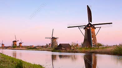 The picturesque landscape with aerial mills on the channel in Kinderdiyk, Netherlands at sunset. Full HD video.
