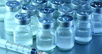 4k close-up of injection bottle&syringe injector.medical equipment&drug vial.